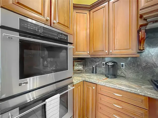 a spacious bedroom with a bed a couch and a window