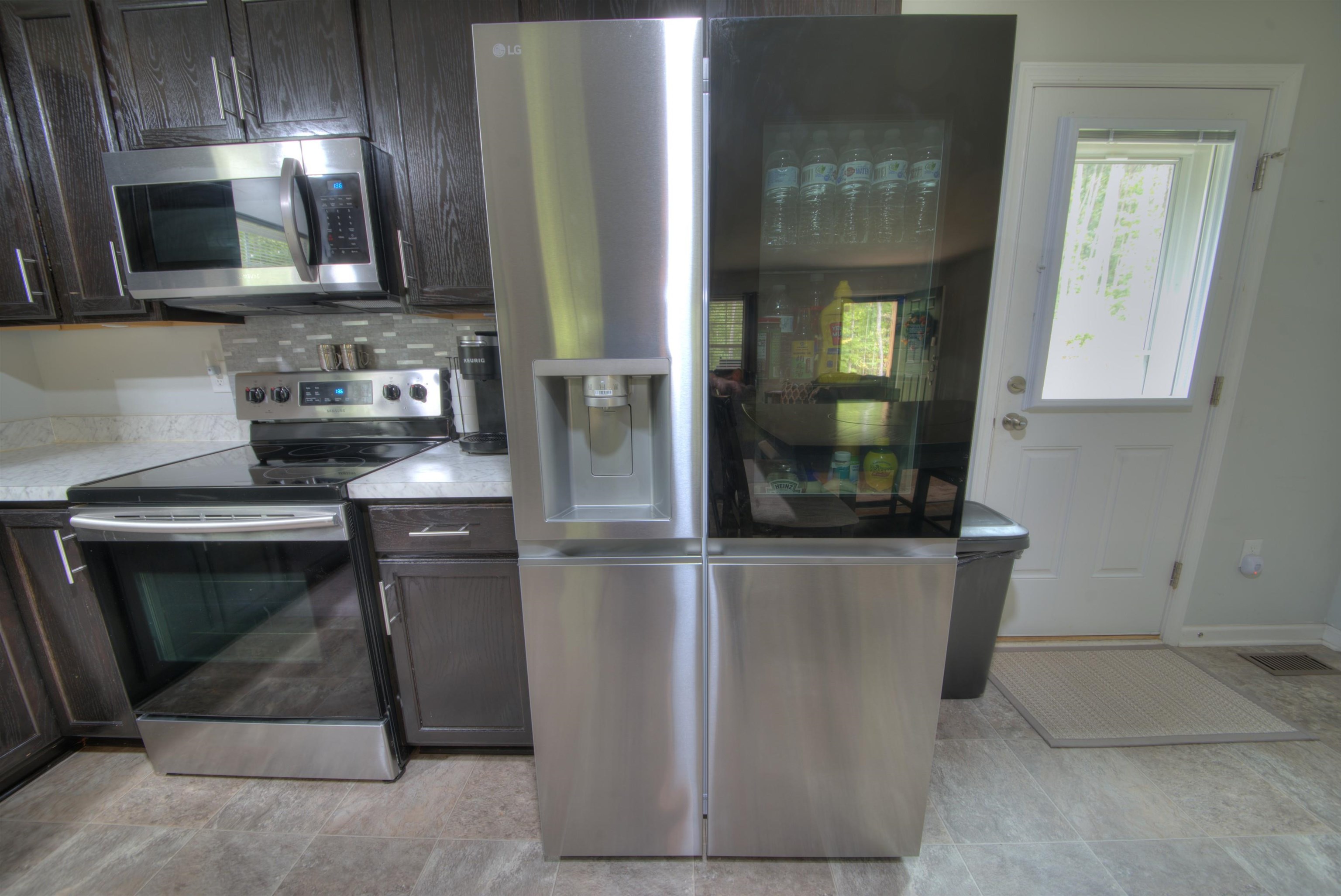 2635 Bumpass Road Bumpass, VA 23024 - Photo 27 of 38 a kitchen with stainless steel appliances granite countertop a stove a microwave and a refrigerator