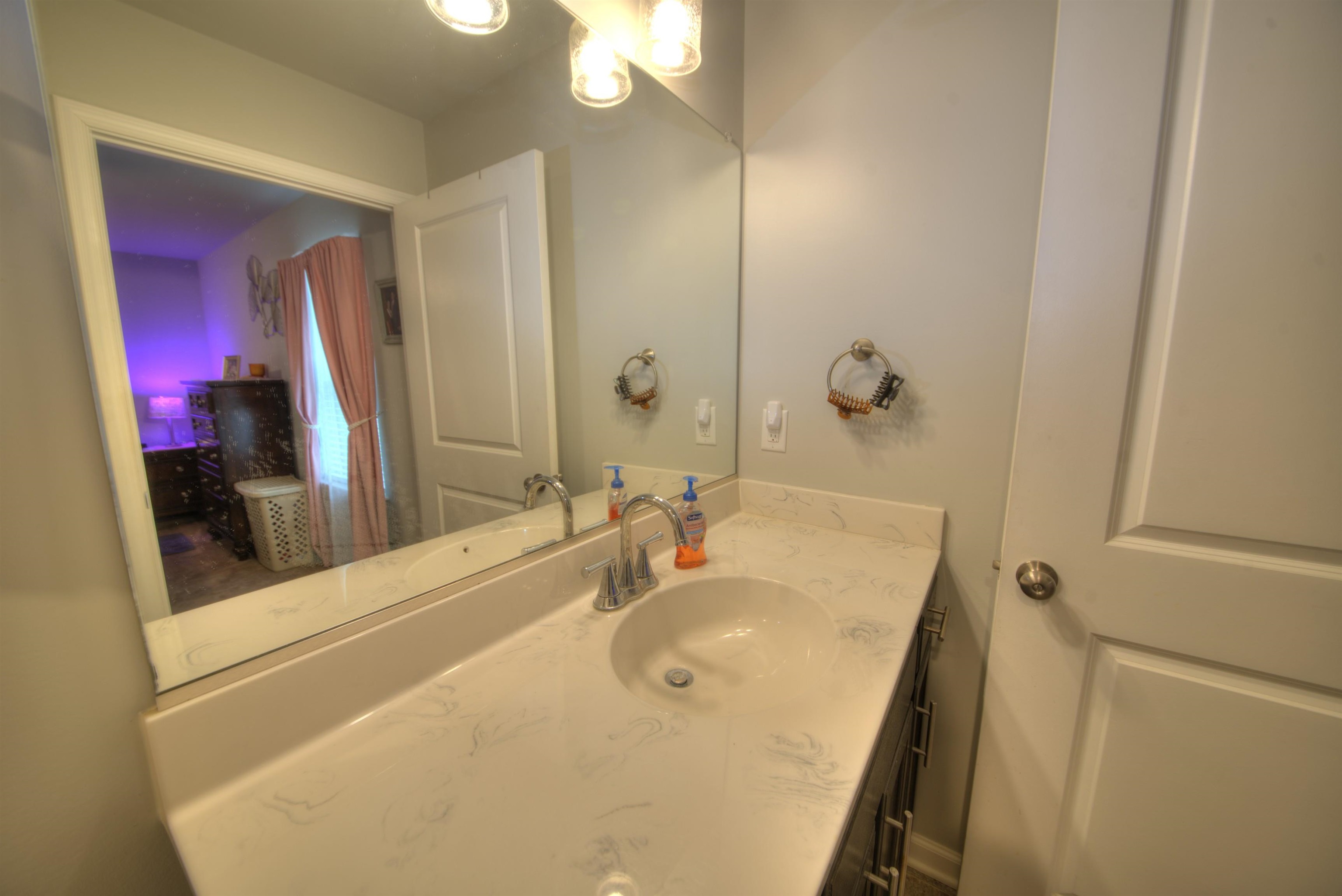 2635 Bumpass Road Bumpass, VA 23024 - Photo 30 of 38 a bathroom with a sink vanity and a mirror