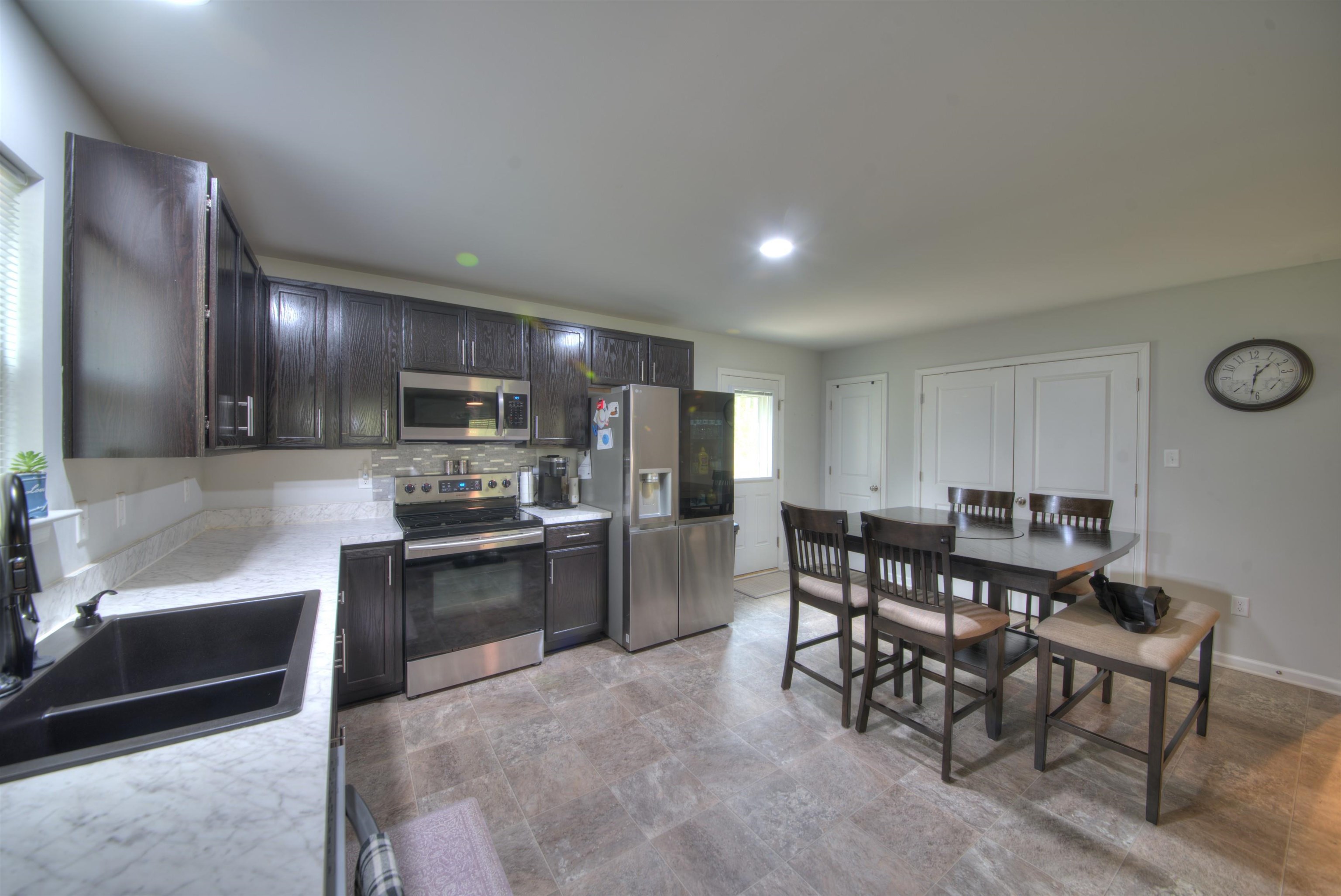 2635 Bumpass Road Bumpass, VA 23024 - Photo 4 of 38 a kitchen with stainless steel appliances kitchen island granite countertop a sink and cabinets