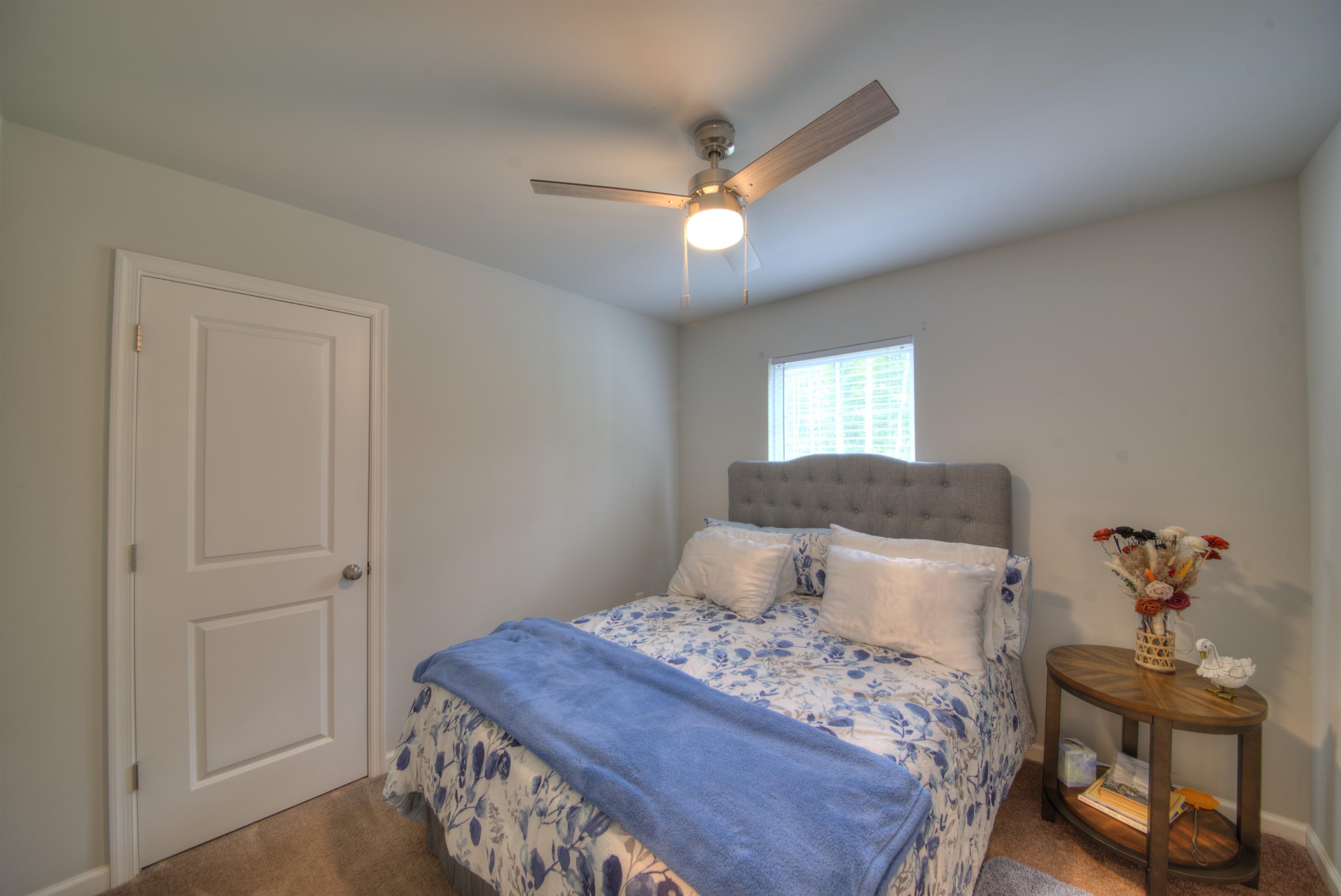 2635 Bumpass Road Bumpass, VA 23024 - Photo 8 of 38 a bedroom with a bed and a chandelier fan
