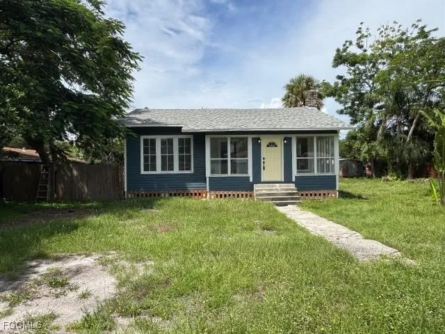 a view of a house with yard and sitting area