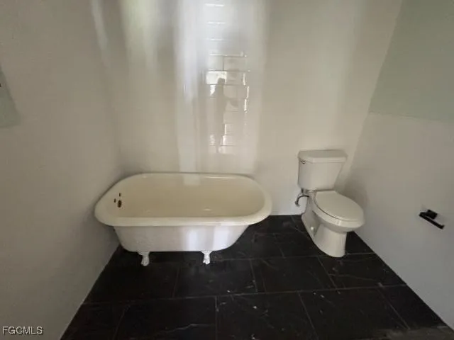a bathroom with a toilet and a sink