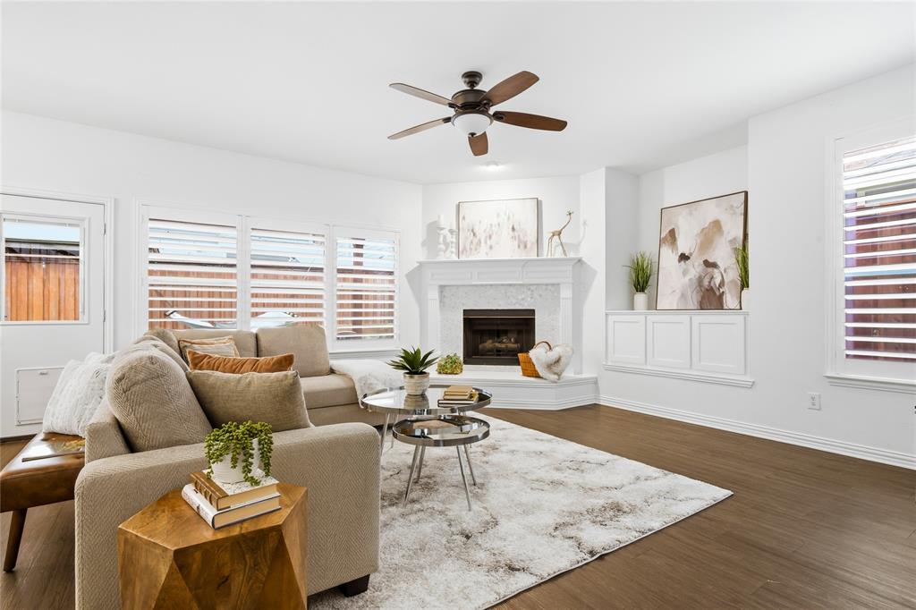 5201 Geode Lane McKinney, TX 75072 - Photo 14 of 37 Family room has lots of natural light with plantation shutters, cozy gas fireplace, entertainment nook with built in cabintry for entertainment equipment.
