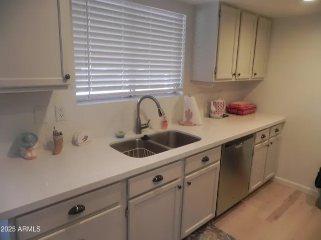 a kitchen with a sink and cabinets
