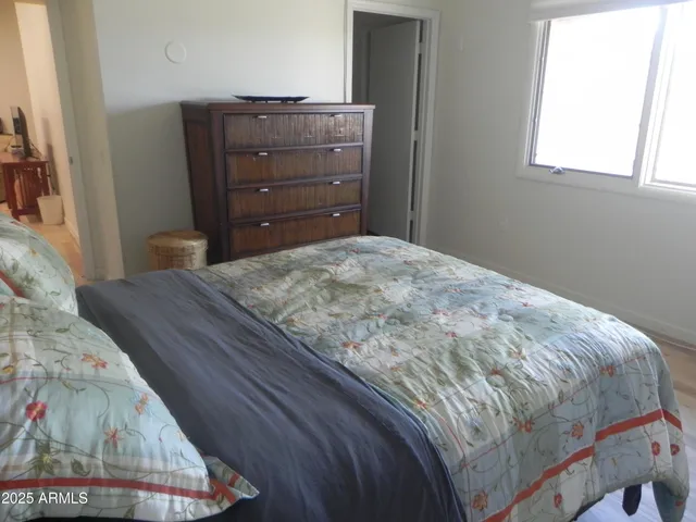 a bedroom with a bed and a window