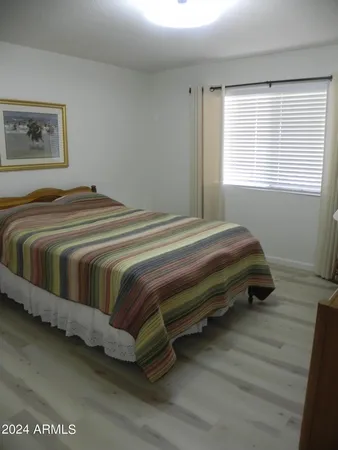 a bedroom with bed and a window