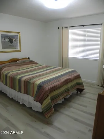 a bedroom with bed and a window