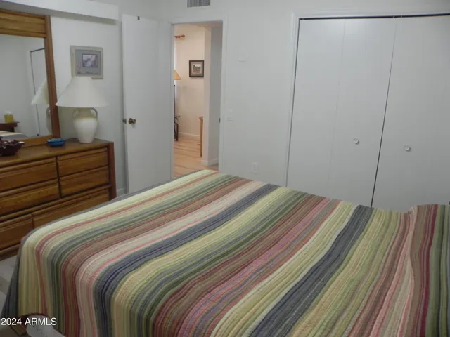 a bedroom with a bed and a lamp