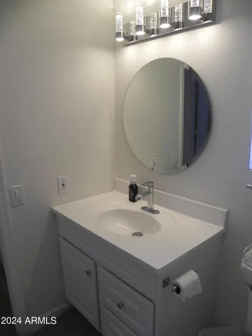a bathroom with a sink and mirror