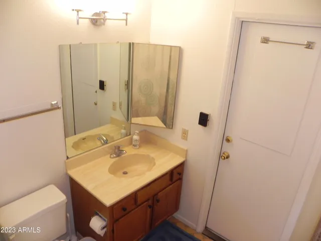 a bathroom with a sink a mirror and shower