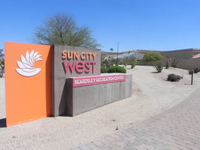 a street sign on a sidewalk next to a road
