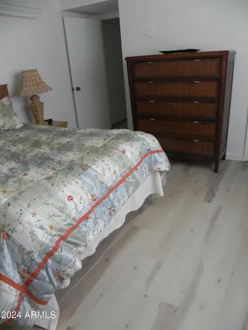 a bedroom with a bed and a dresser