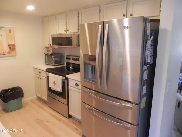 a kitchen with stainless steel appliances a refrigerator stove and microwave