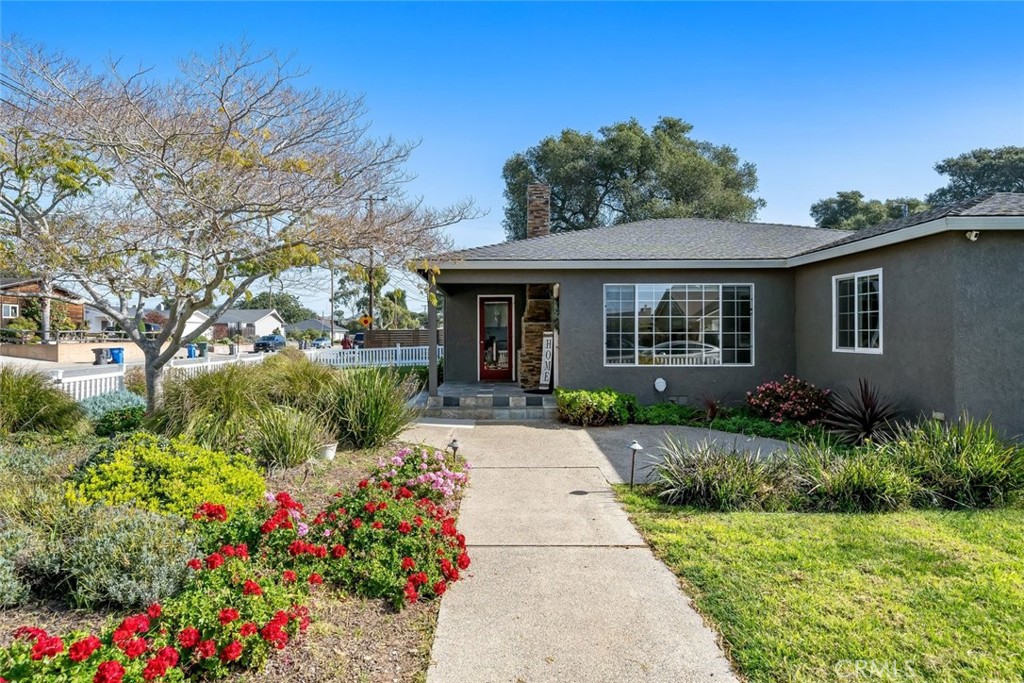 403 Beech Street Arroyo Grande, CA 93420 - Photo 1 of 46 a front view of a house with a yard and potted plants