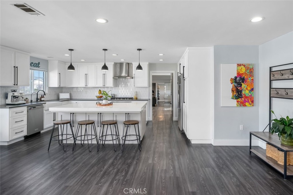 403 Beech Street Arroyo Grande, CA 93420 - Photo 11 of 46 a kitchen with stainless steel appliances a dining table chairs stove refrigerator and cabinets