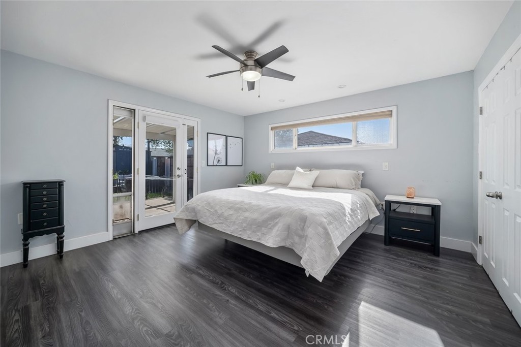 403 Beech Street Arroyo Grande, CA 93420 - Photo 18 of 46 a bedroom with a large bed chandelier and a window