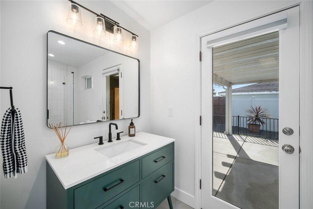 403 Beech Street Arroyo Grande, CA 93420 - Photo 26 of 46 a bathroom with a sink a mirror and shower