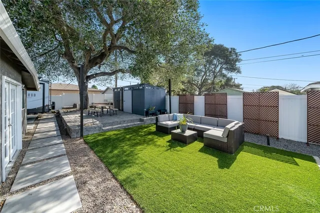a view of a house with backyard and sitting area