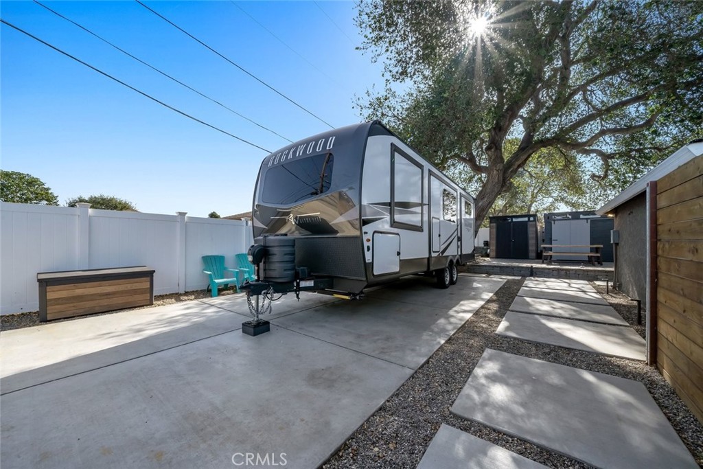 403 Beech Street Arroyo Grande, CA 93420 - Photo 35 of 46 a view of a patio with table and chairs with wooden fence and plants