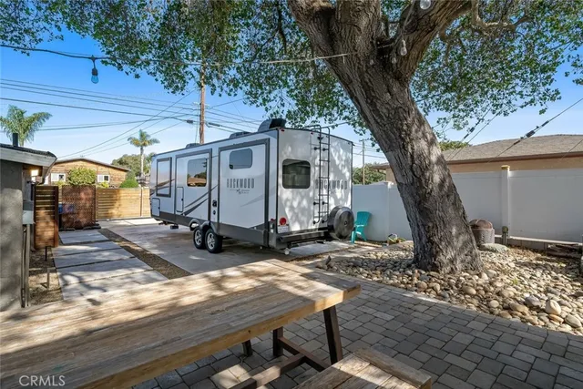 a view of a patio with table and chairs with wooden fence and plants