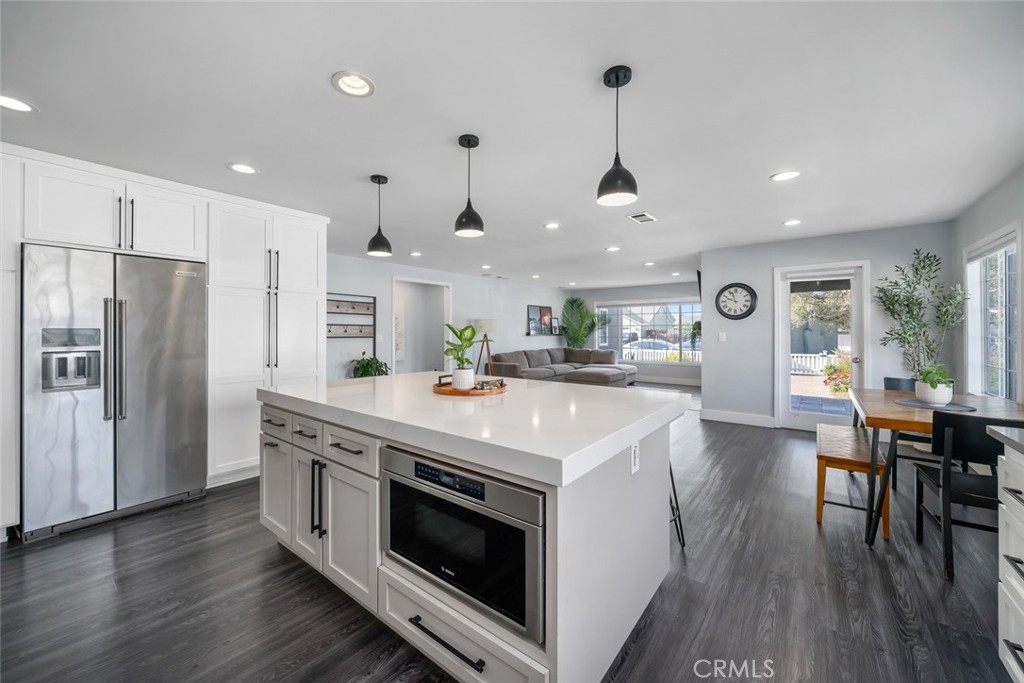 403 Beech Street Arroyo Grande, CA 93420 - Photo 4 of 46 a kitchen with kitchen island white cabinets and stainless steel appliances