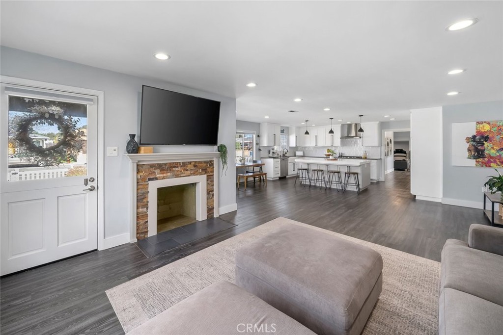 403 Beech Street Arroyo Grande, CA 93420 - Photo 7 of 46 a living room with furniture a fireplace and a flat screen tv