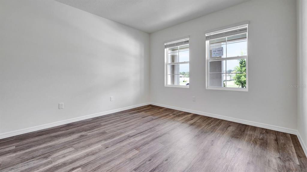 3598 Roden Road Haines City, FL 33844 - Photo 13 of 26 an empty room with wooden floor and windows