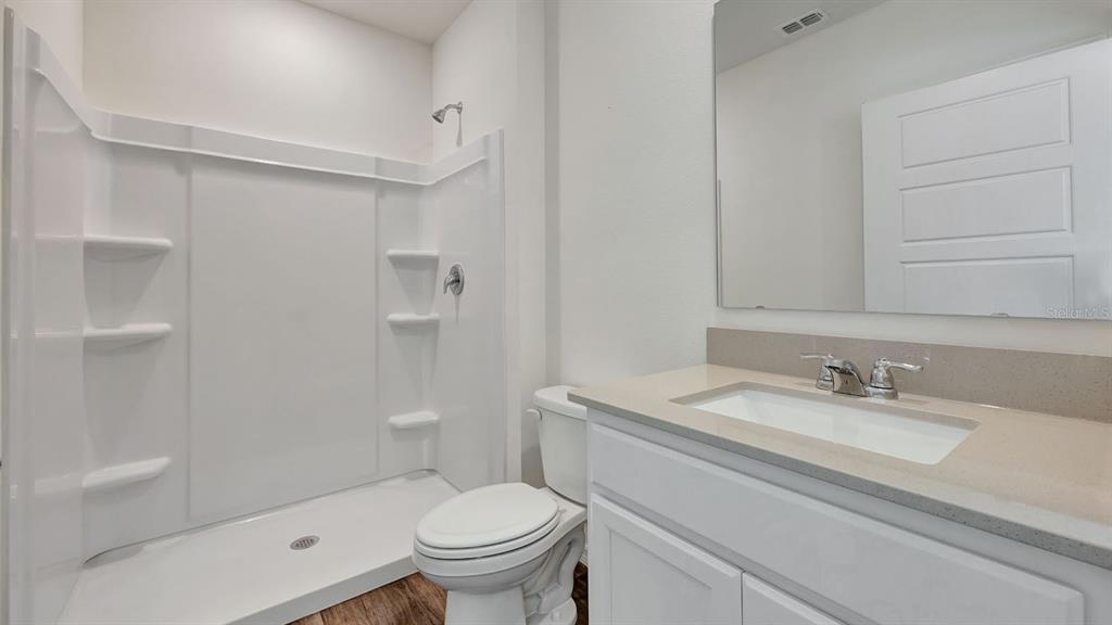 3598 Roden Road Haines City, FL 33844 - Photo 16 of 26 a bathroom with a sink toilet and shower