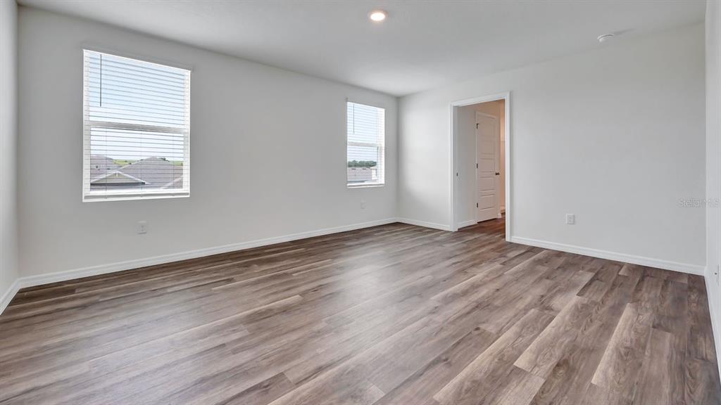 3598 Roden Road Haines City, FL 33844 - Photo 18 of 26 an empty room with wooden floor and windows