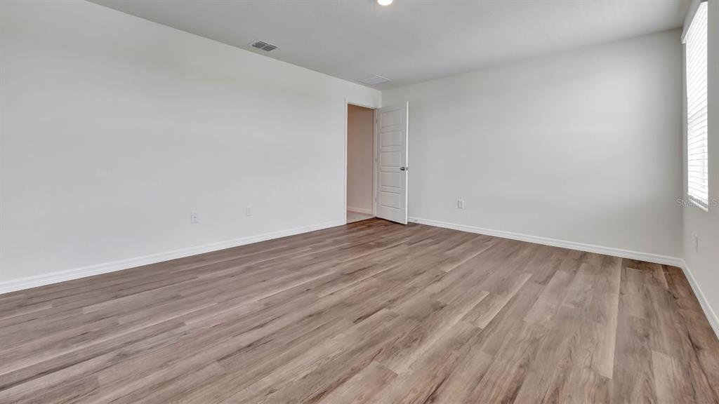 3598 Roden Road Haines City, FL 33844 - Photo 19 of 26 a view of an empty room with wooden floor