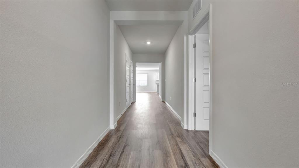 3598 Roden Road Haines City, FL 33844 - Photo 2 of 26 a view of a hallway with wooden floor
