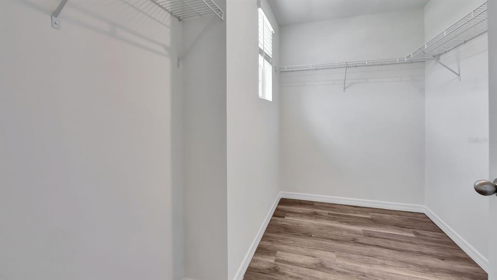 3598 Roden Road Haines City, FL 33844 - Photo 22 of 26 a walk in closet with wooden floor
