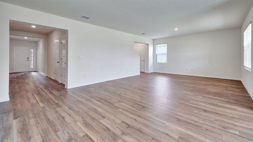 3598 Roden Road Haines City, FL 33844 - Photo 4 of 26 an empty room with wooden floor and windows