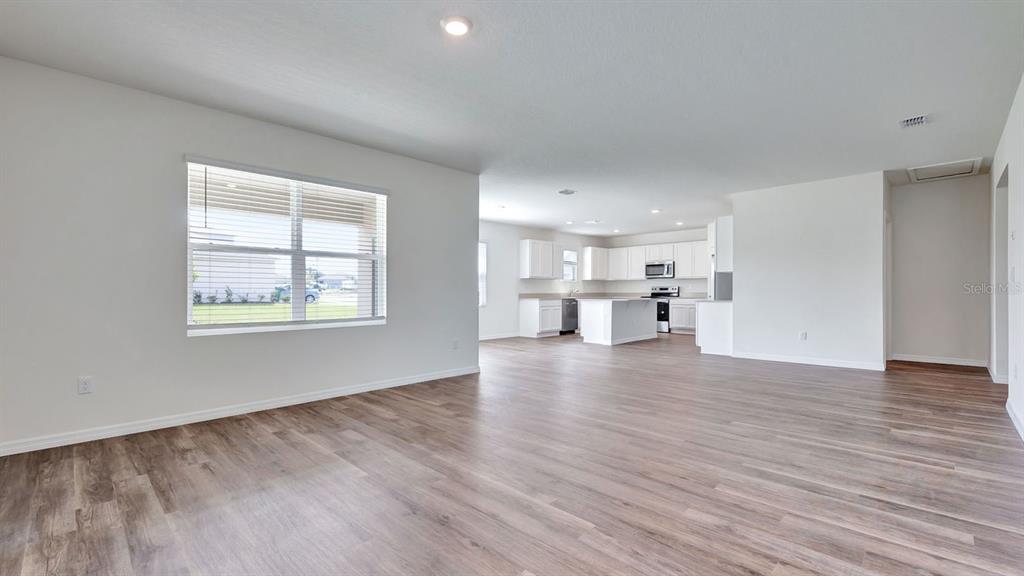 3598 Roden Road Haines City, FL 33844 - Photo 5 of 26 a view of empty room with wooden floor and windows