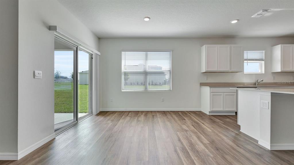 3598 Roden Road Haines City, FL 33844 - Photo 7 of 26 an empty room with wooden floor and a window