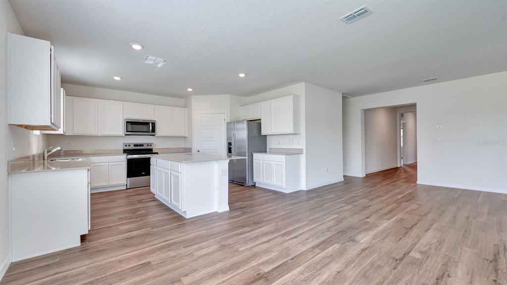 3598 Roden Road Haines City, FL 33844 - Photo 8 of 26 a view of kitchen with wooden floor and electronic appliances