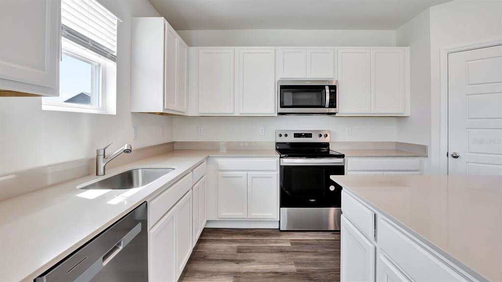 3598 Roden Road Haines City, FL 33844 - Photo 10 of 26 a kitchen with a sink stove and microwave