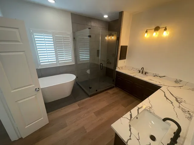 a bathroom with a tub sink and mirror