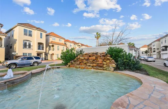 a view of a patio with table and chairs with wooden fence