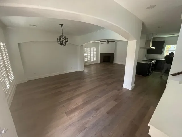 a view of a room with wooden floor and staircase
