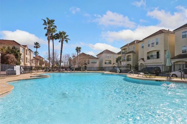 a view of a house with swimming pool and a yard