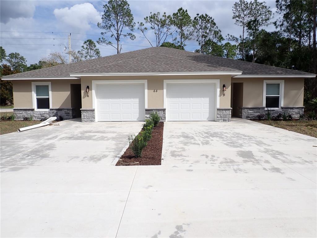 44 Slumber Path, Unit B Palm Coast, FL 32164 - Photo 1 of 1 a view of a house with a patio and yard
