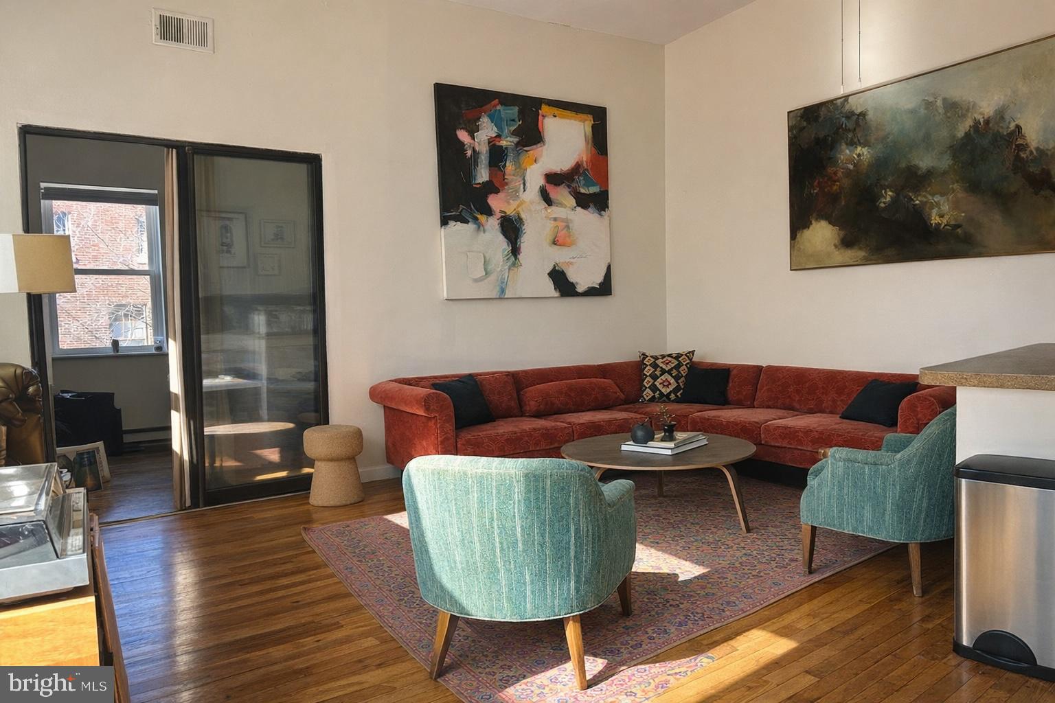 407 South 10th Street, Unit 2 Philadelphia, PA 19147 - Photo 2 of 5 a living room with furniture and a view of kitchen