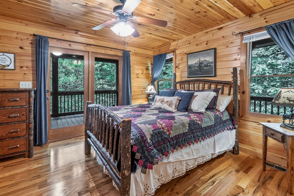 115 Lakota Trail Blue Ridge, GA 30513 - Photo 14 of 49 a bedroom with a bed a large window with the outer view