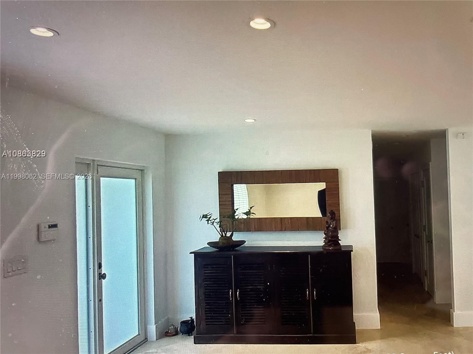 10900 Southwest 107th Avenue Miami, FL 33176 - Photo 11 of 26 a living room with mirror