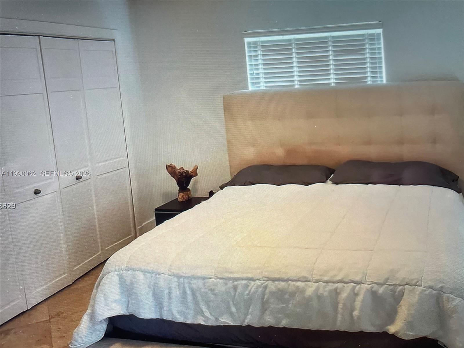 10900 Southwest 107th Avenue Miami, FL 33176 - Photo 13 of 26 a bedroom with a bed and window
