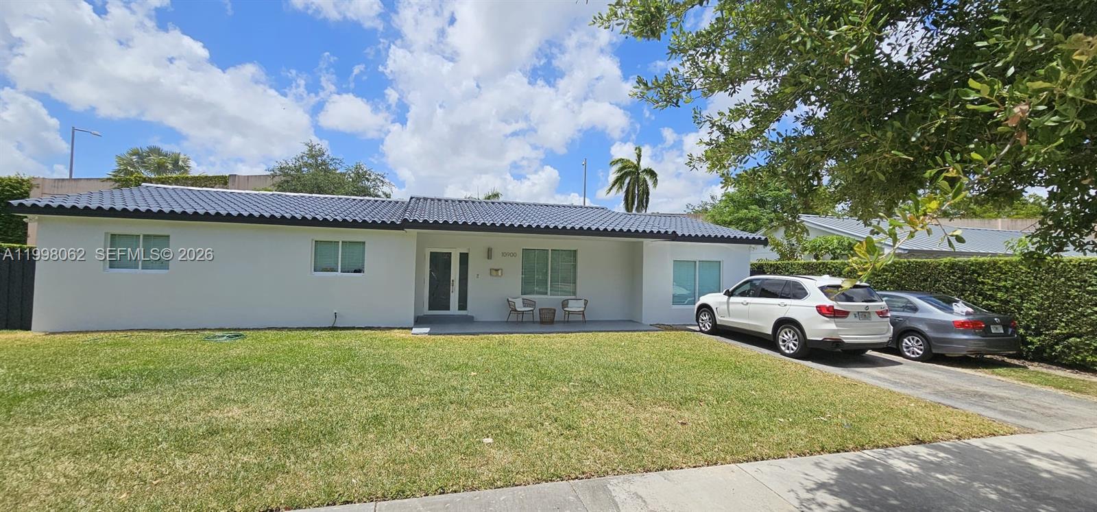 10900 Southwest 107th Avenue Miami, FL 33176 - Photo 2 of 26 a front view of house with yard and car parked