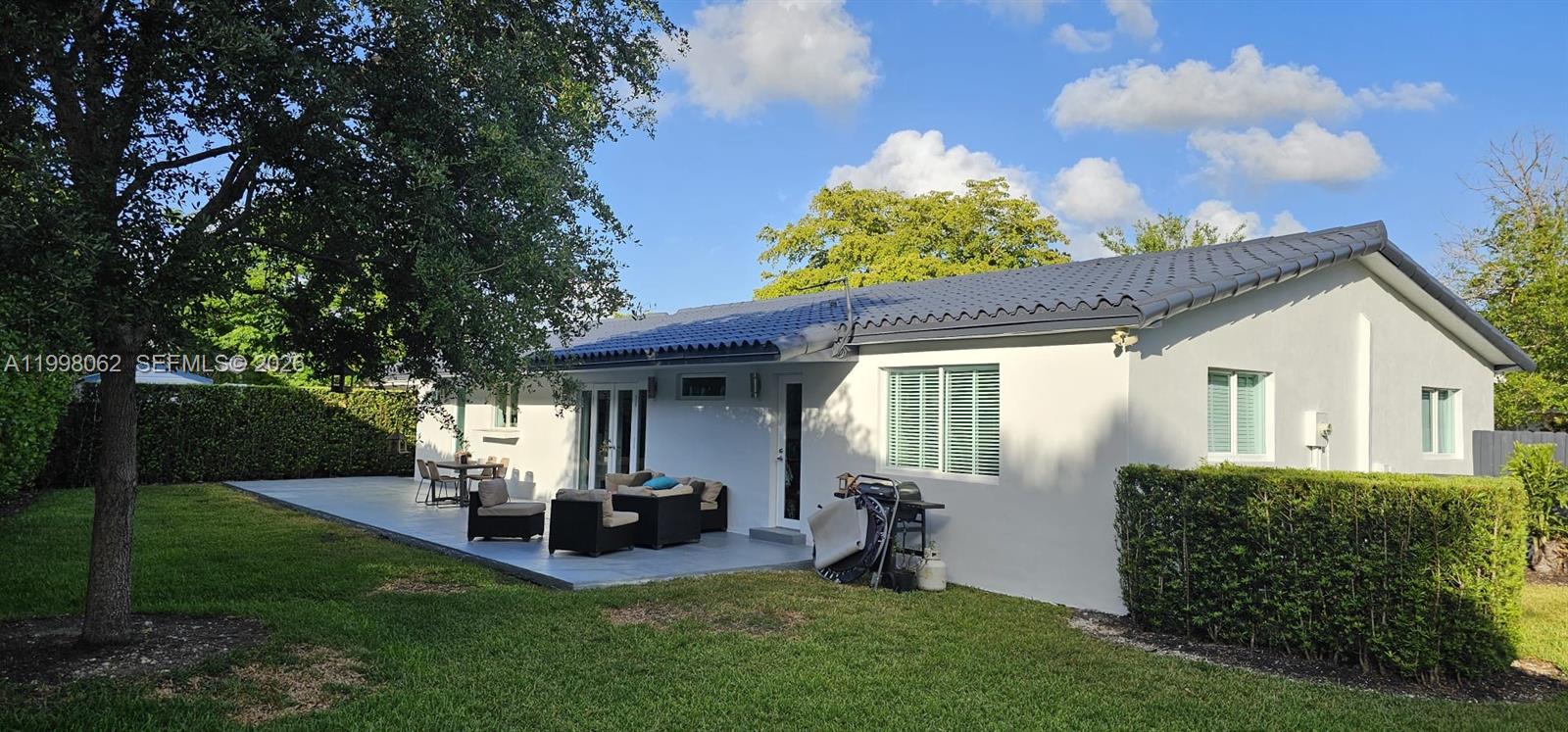 10900 Southwest 107th Avenue Miami, FL 33176 - Photo 22 of 26 a view of a house with backyard sitting area and garden
