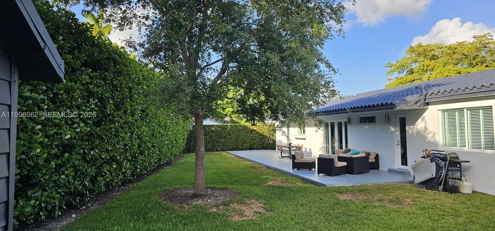 10900 Southwest 107th Avenue Miami, FL 33176 - Photo 23 of 26 a view of a house with backyard porch and sitting area